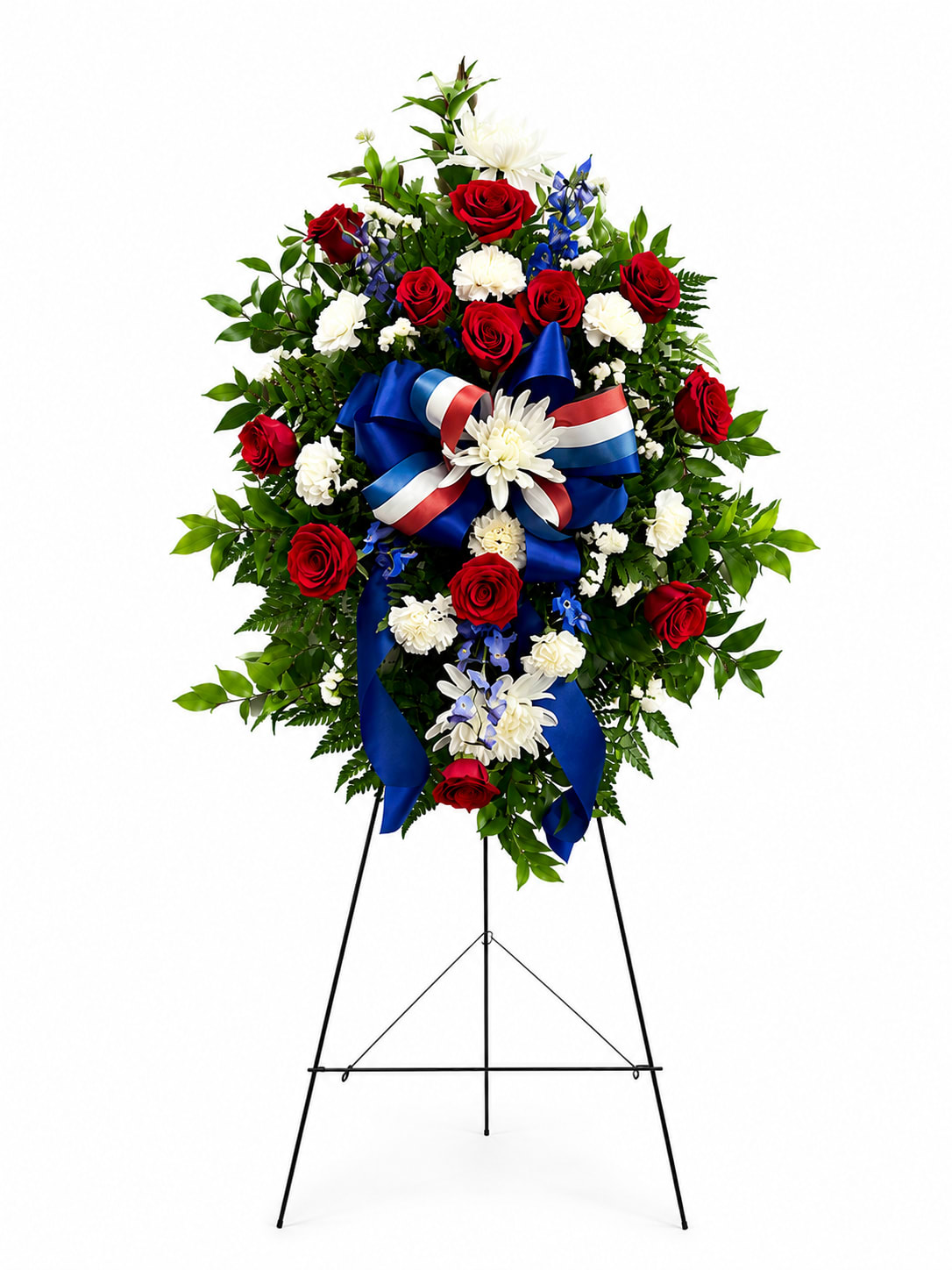 Standing floral wreath with red and white flowers and a blue ribbon on an easel