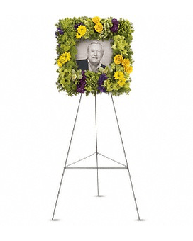 Standing floral tribute with a portrait in the center