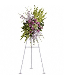 Standing floral spray with purple flowers on a metal easel