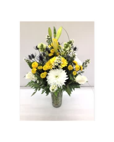 Yellow and white floral arrangement in a glass vase