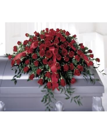 Large red rose casket spray with trailing greenery