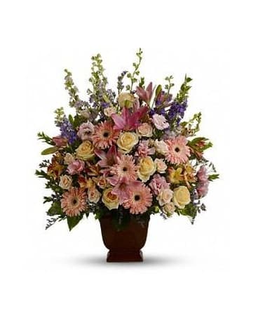Large mixed flower arrangement in a dark vase