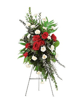 Standing spray of red roses and white carnations on an easel