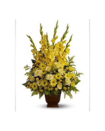Tall yellow floral arrangement in a brown urn