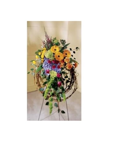Tall mixed flower arrangement on a metal stand