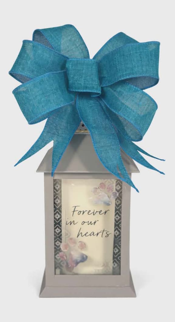 "In Our Hearts" Animal Print Lighted Lantern - "In Our Hearts" Animal Print Lighted Lantern has a flameless LED candle and is made of high-quality polyresin. They have a built in automatic timer, 6 hrs. ON/18 hrs. OFF (3 AAA batteries included). Comes with a matching bow.   W: 4" H: 11 " D: 4 "