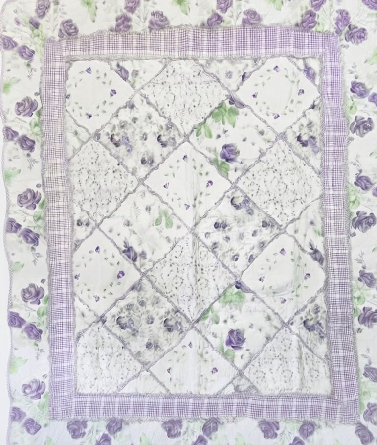 Quilt with purple rose floral print and patchwork center panel