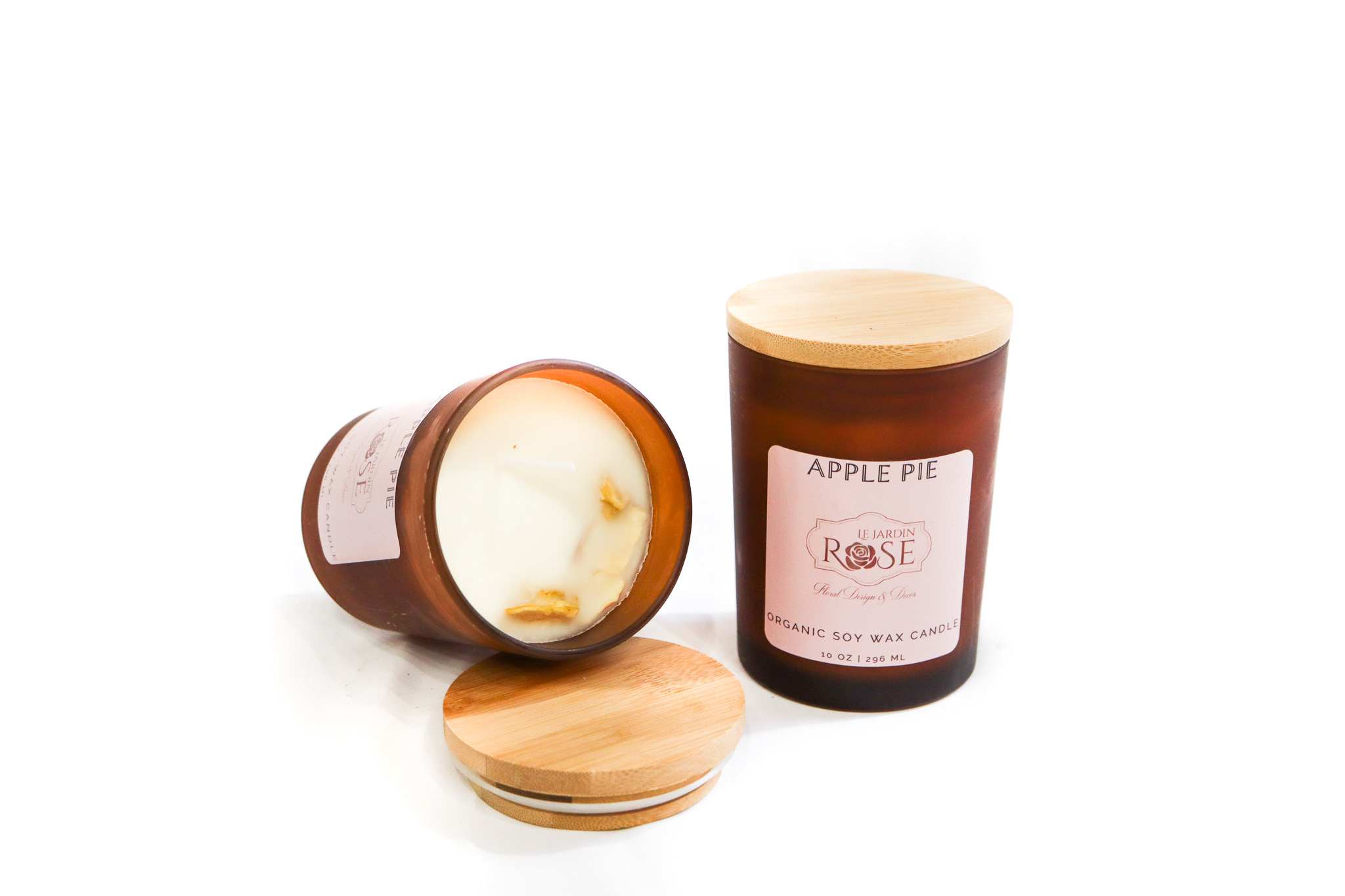 Two apple pie scented candles in amber glass jars with wooden lids
