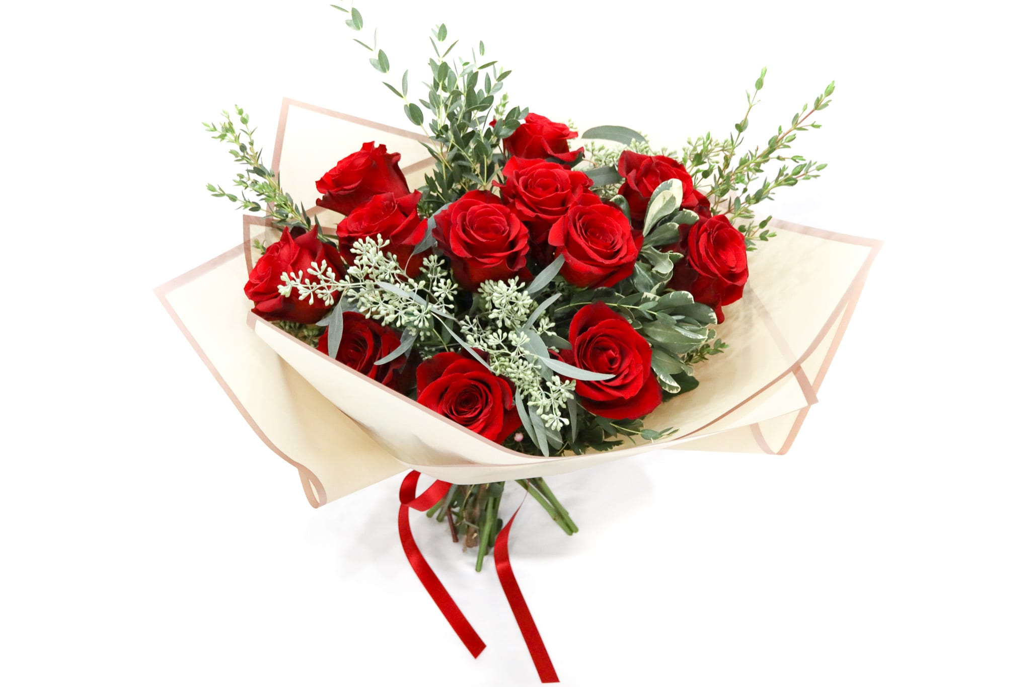 Bouquet of red roses wrapped in cream paper with a red ribbon