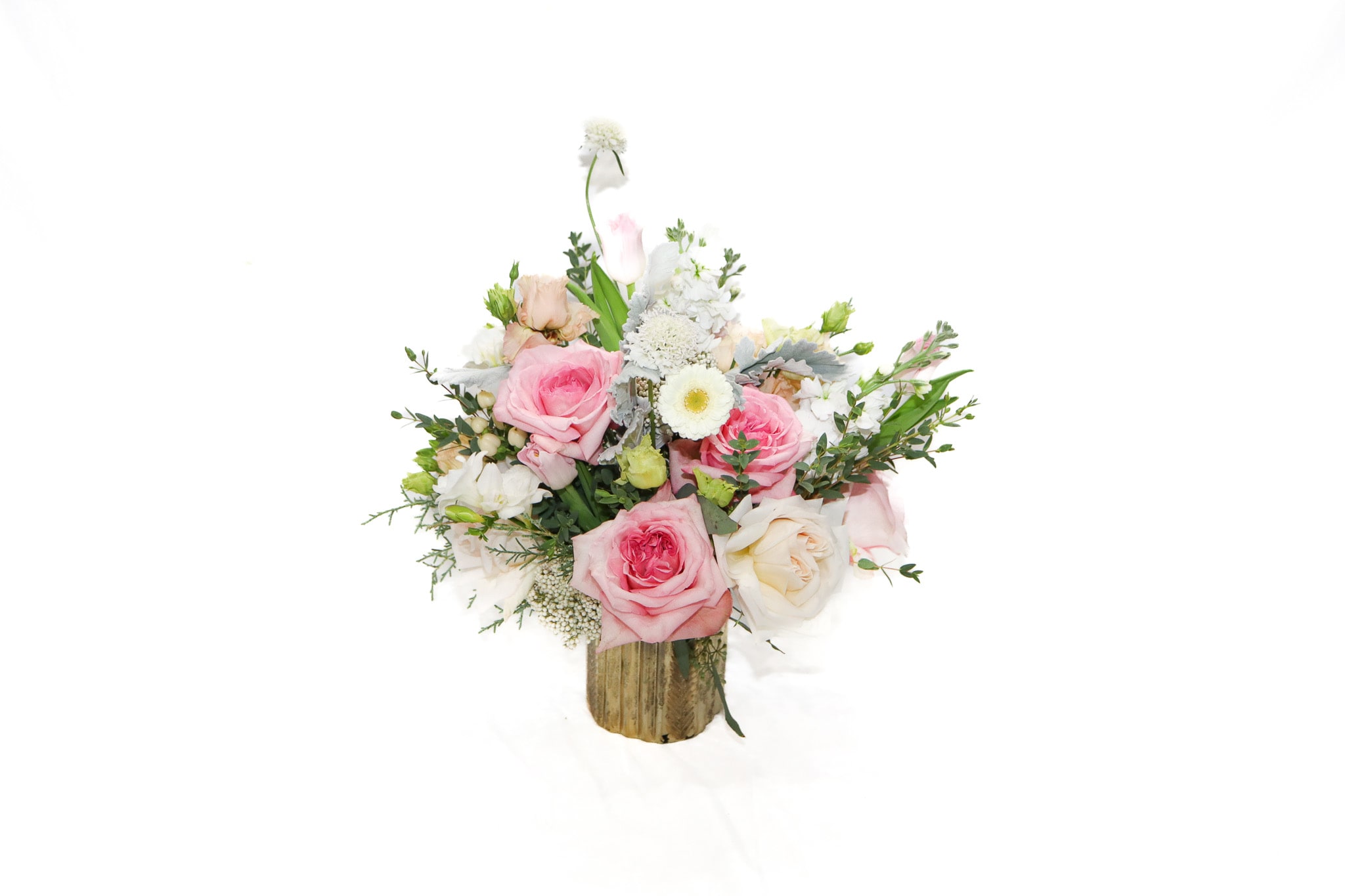 Pink and white rose bouquet in a rustic wooden container
