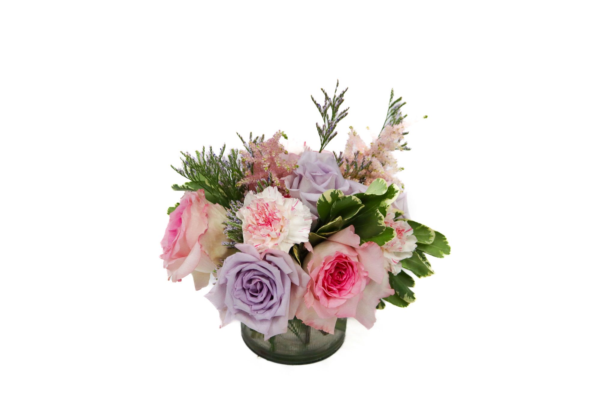 Bouquet of pink and lavender roses in a glass vase