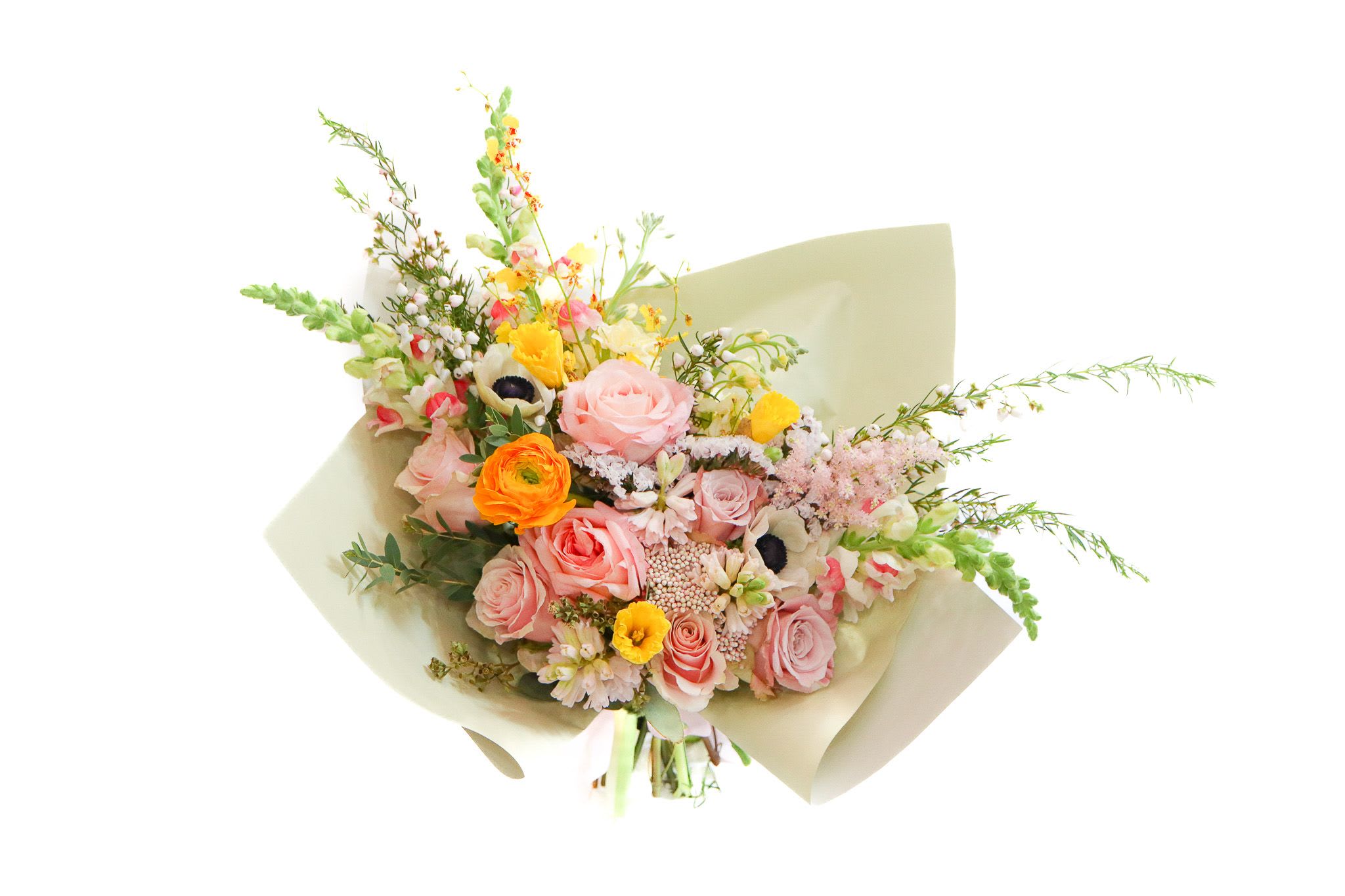 Bouquet of pink and orange flowers wrapped in pale paper