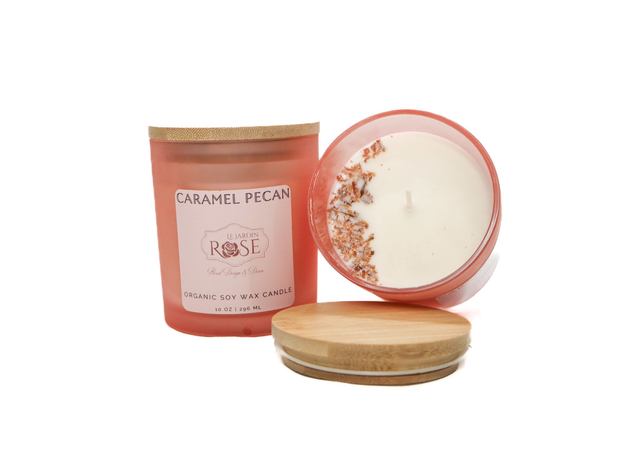 Two caramel pecan candles with wooden lids on a white background