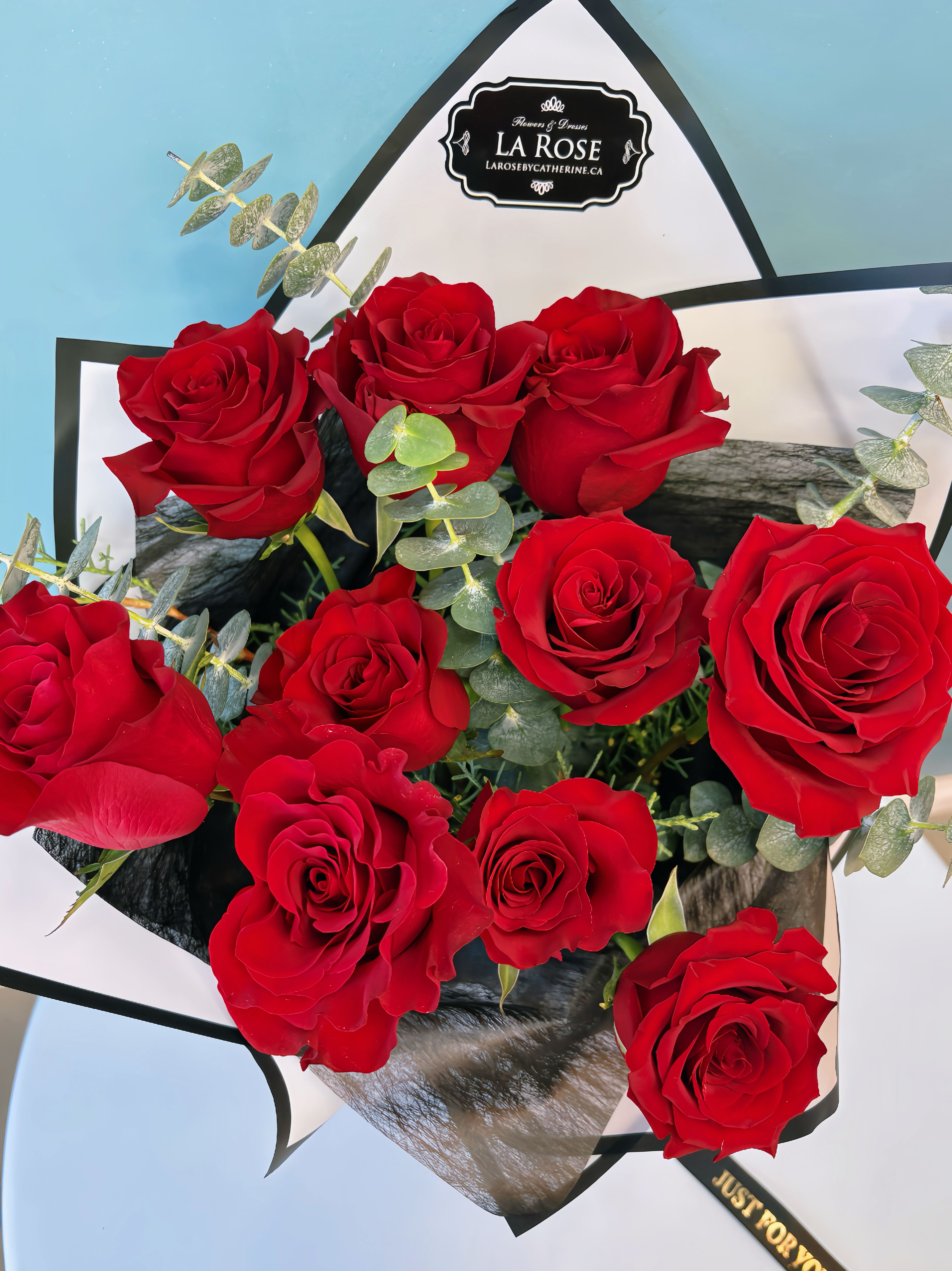 Bouquet of red roses wrapped in black and white paper