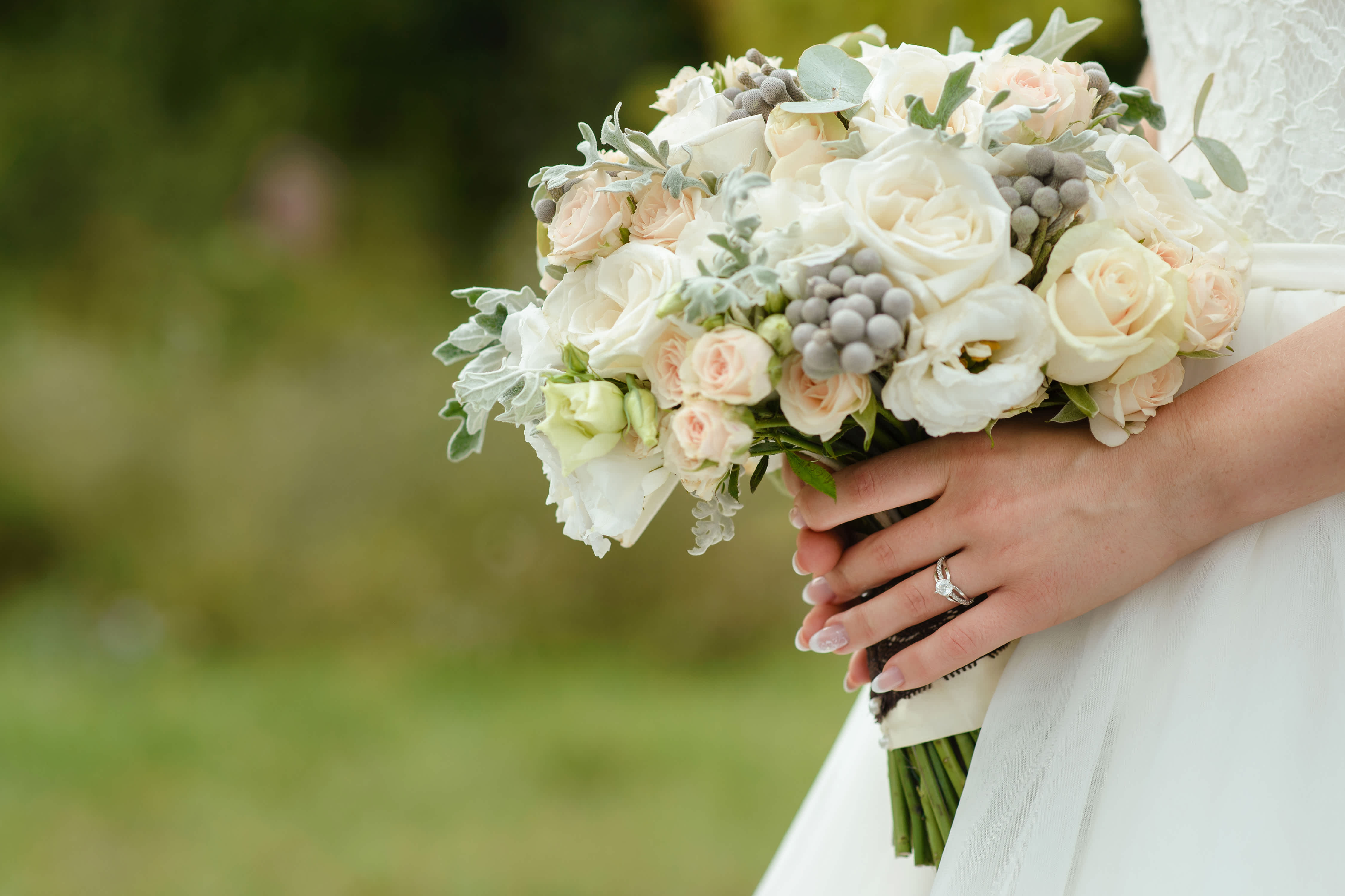 Bride holding a white and blush rose bouquet