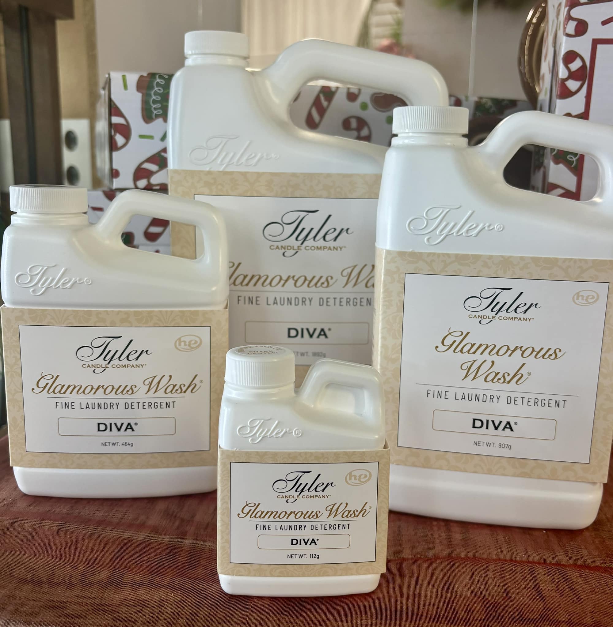 Four bottles of Tyler Glamorous Wash laundry detergent on a table