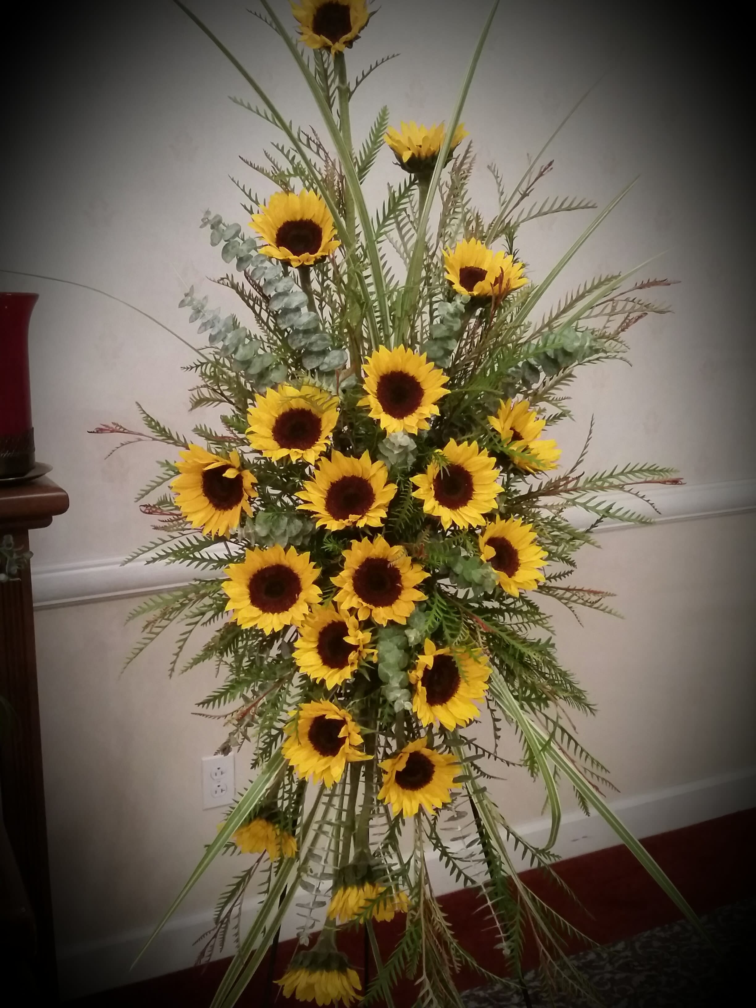 Tall sunflower arrangement with yellow blooms and mixed greenery