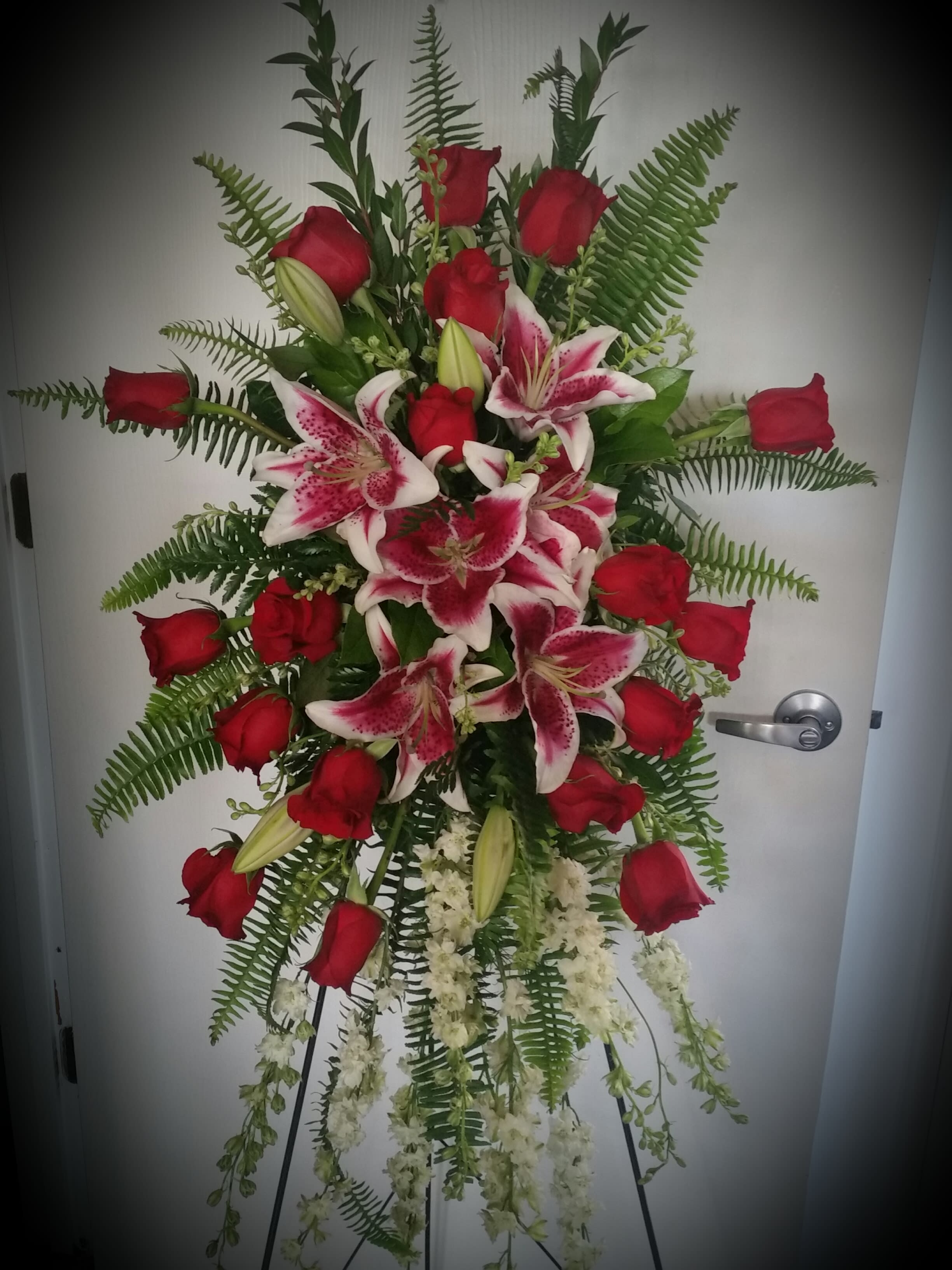 Rose and Lily Easel designed by The Potted  Plant - Red roses, Stargazer Lilies and White Larkspur create this loving tribute. This piece can also be done all white or pink.