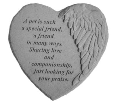 Heart-shaped stone plaque with engraved angel wing and memorial text