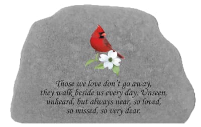 Gray memorial stone with a red cardinal and white flower
