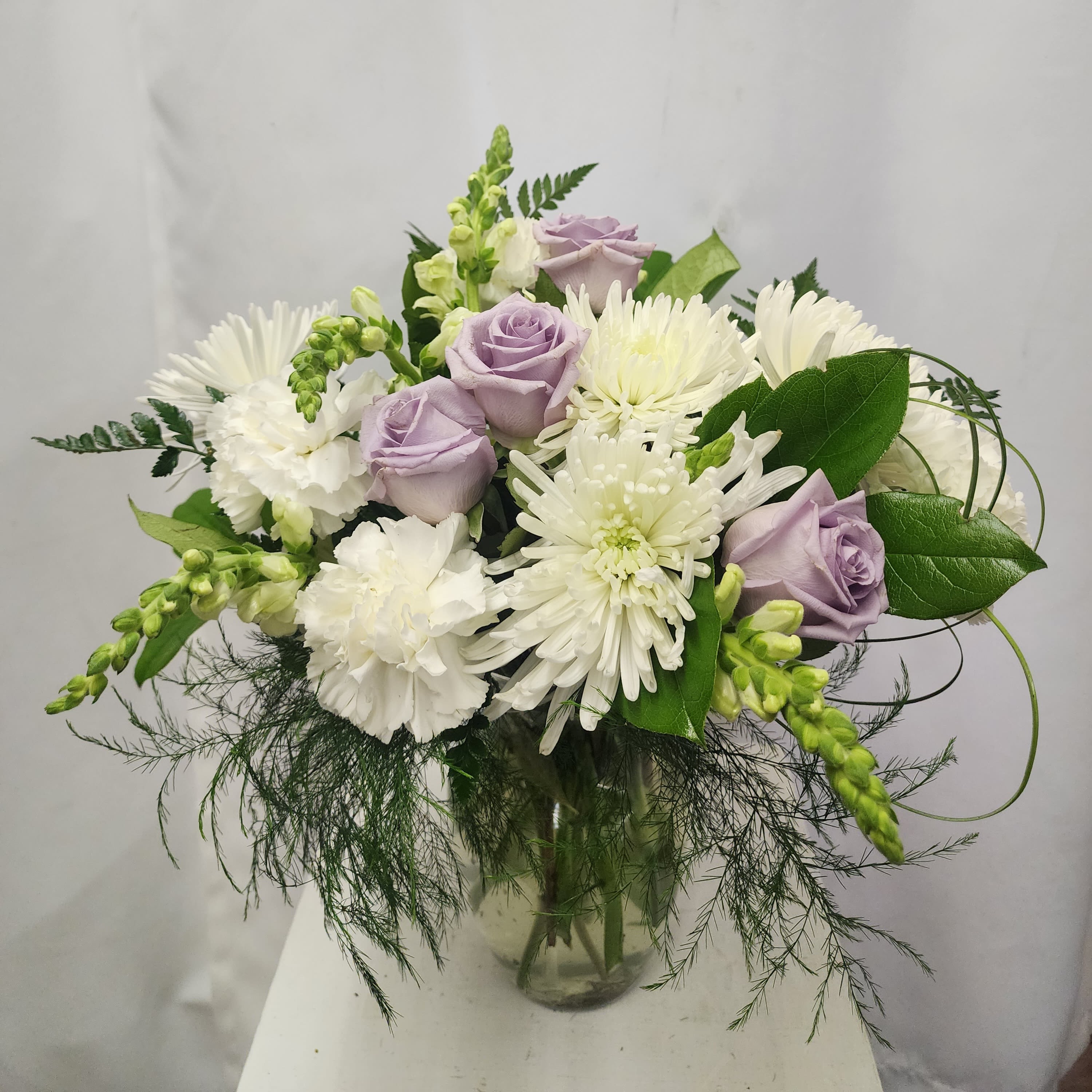 Lavender Serenity - A soft and elegant way to express your love, gratitude or condolences.  Appropriate for many occasions. The arrangement says "thinking of you", for memorials as well as "love you", for special times.  Arrangement will appear as close to photo as possible. 
