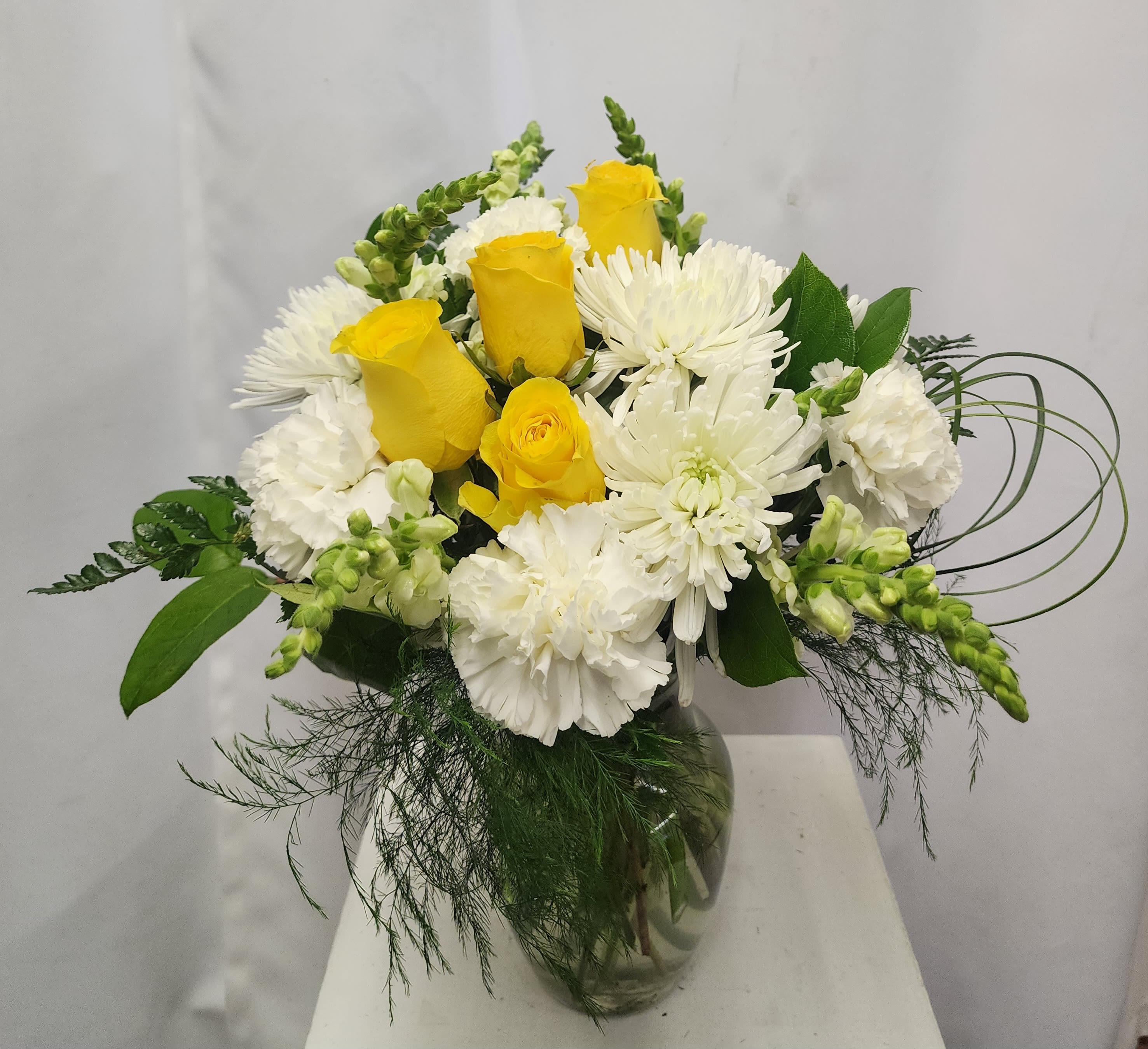 Yellow Serenity - A soft and elegant way to express your love, gratitude or condolences.  Appropriate for many occasions. The arrangement says "thinking of you", for memorials as well as "love you", for special times.  Arrangement will appear as close to photo as possible. 