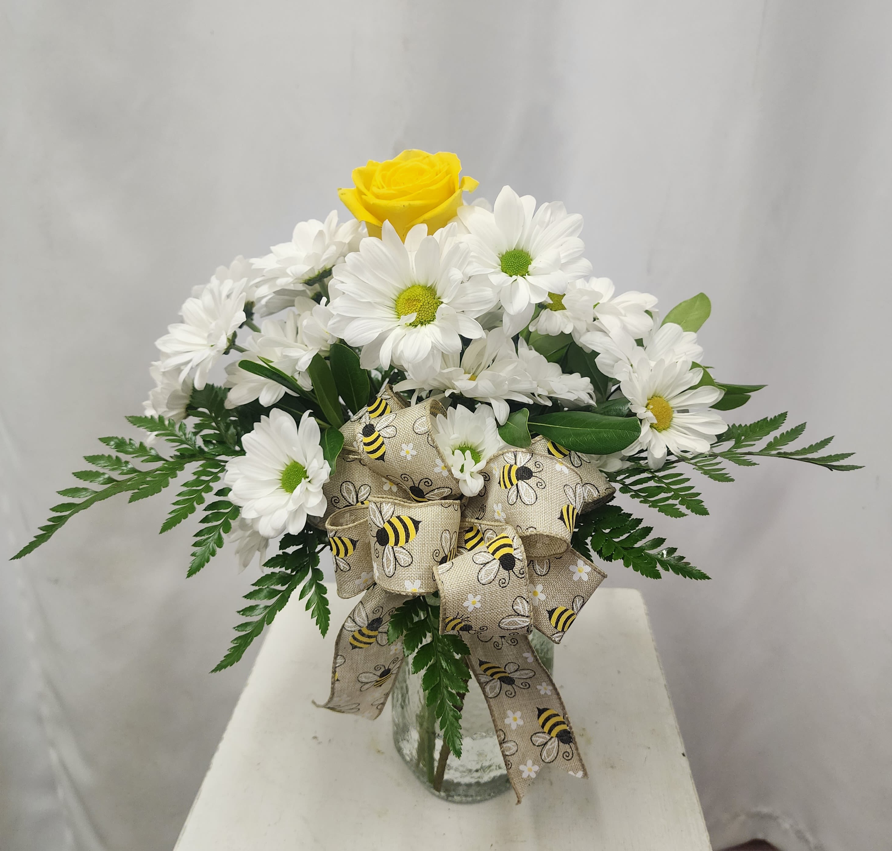 Bee-cause - Brighten someone's day with this simple, adorable, and cheery arrangement. Bright white daisies, a yellow rose, and a burlap bumble bee bow. Deliver a smile - just bee-cause!