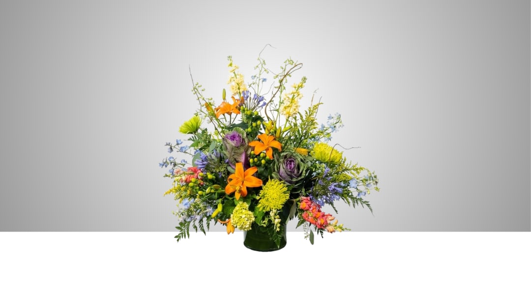 Colorful mixed flower arrangement in a dark vase