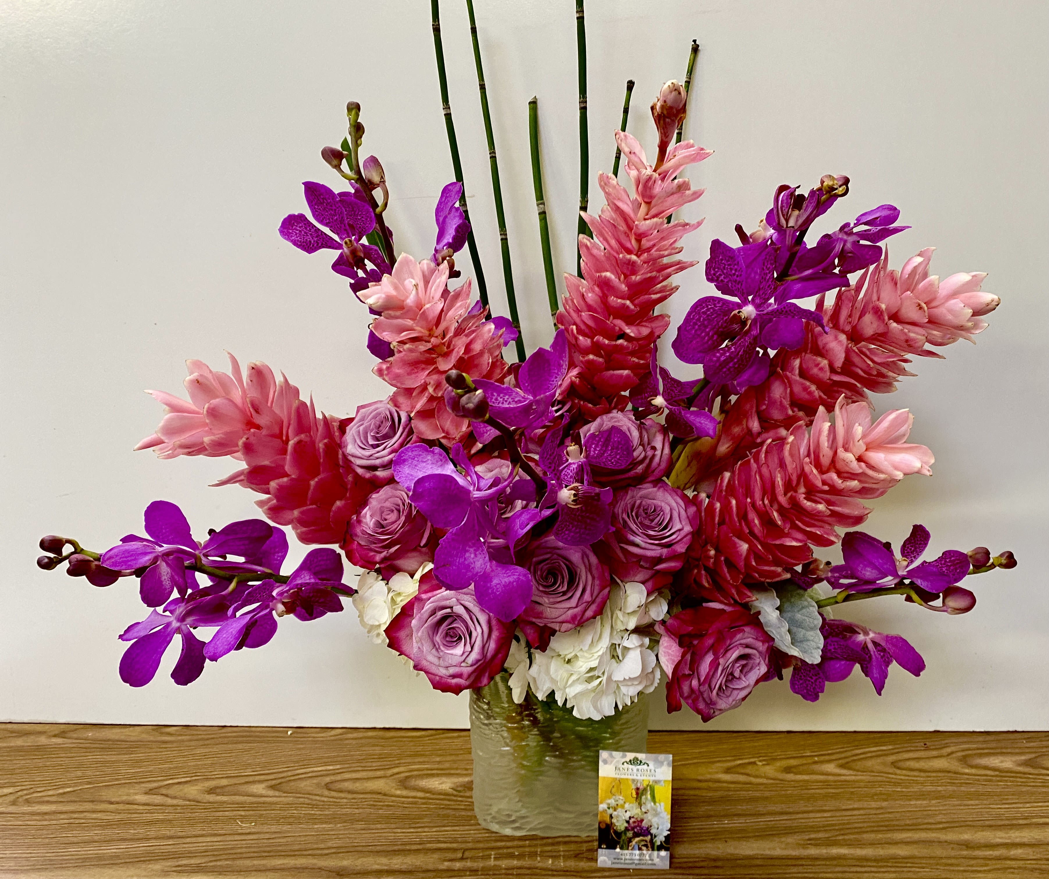 Pink and purple floral arrangement in a glass vase