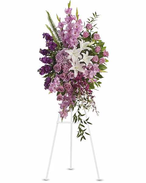 Tall purple and white floral standing spray on an easel