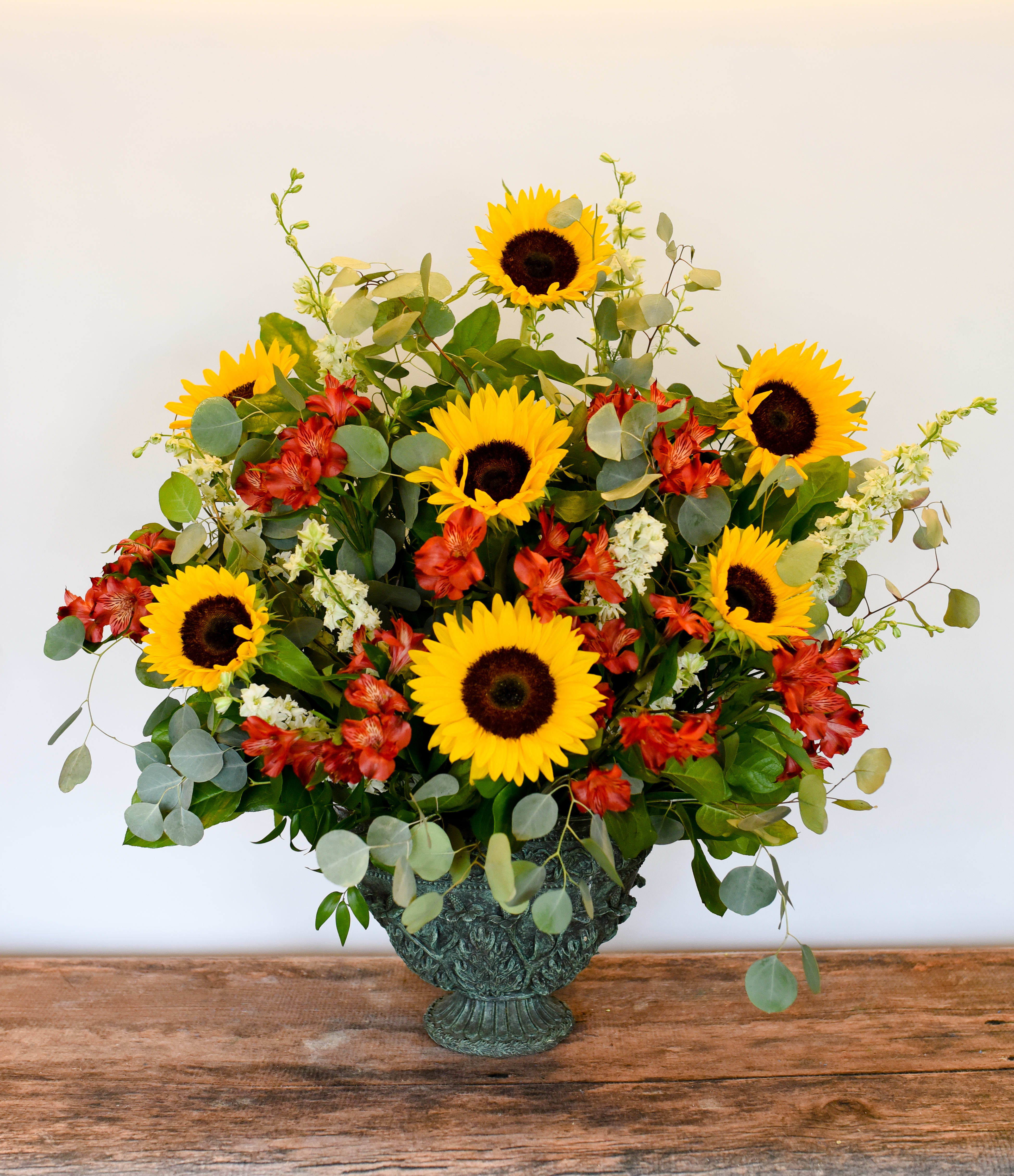 Sunflower and red alstroemeria arrangement in a decorative vase