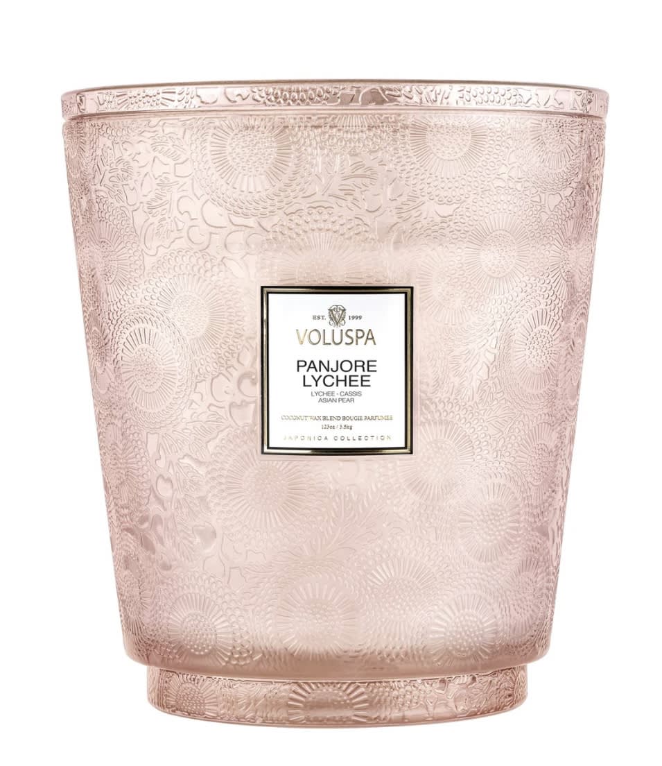 Pink patterned candle in a decorative glass vessel