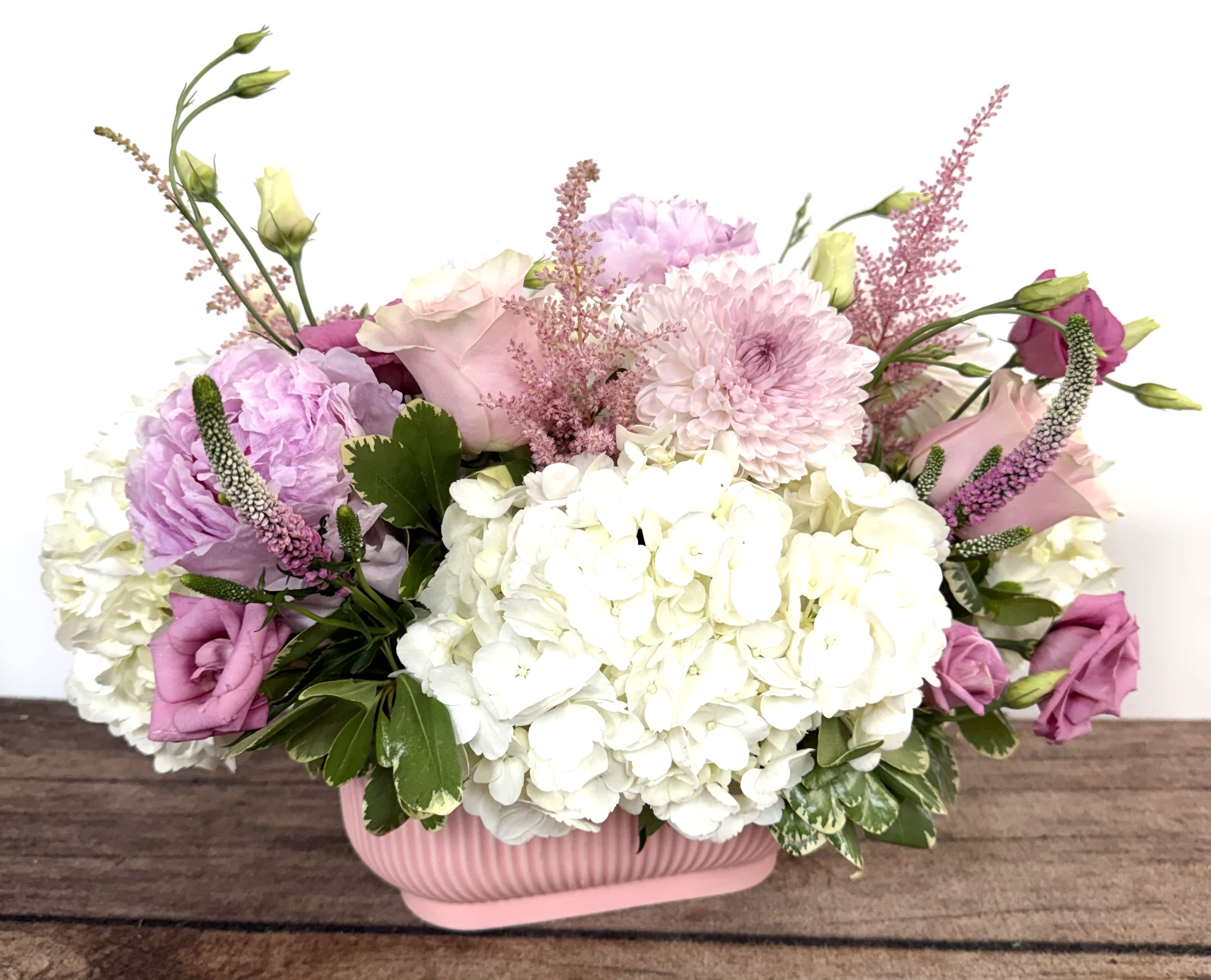 Quartz - Blush pink blooms beautifully designed in a pink ceramic, textured container. Approx. 16"w x 12"h