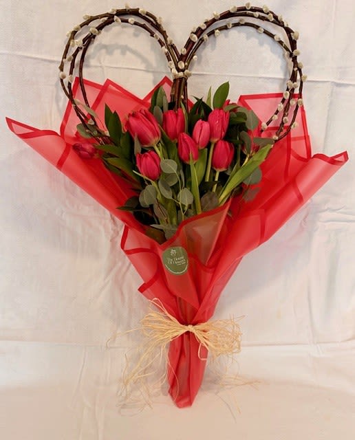 My human Goddess by The House of Flowers - A beautiful bouquet of tulips with a natural heart-shaped base, perfect for showing your love and devotion to your partner on Valentine's Day. You can also include a cute teddy bear and/or a box of chocolates. 