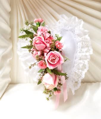 Pink rose corsage with white ruffled trim and ribbon