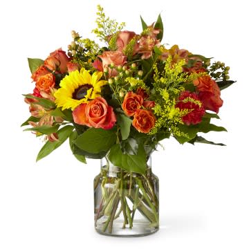 Sunnycrisp Bouquet - A morning stroll through a buzzing garden with the Sunnycrisp bouquet that simply beams with happy blooms. Watch sunflowers follow the light around the autumn roses and hypericum berries, all tied together with yellow asters.  21-F6P