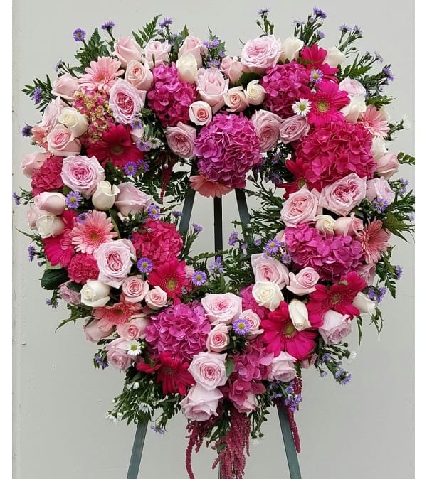Heart-shaped floral wreath with pink roses and gerbera daisies