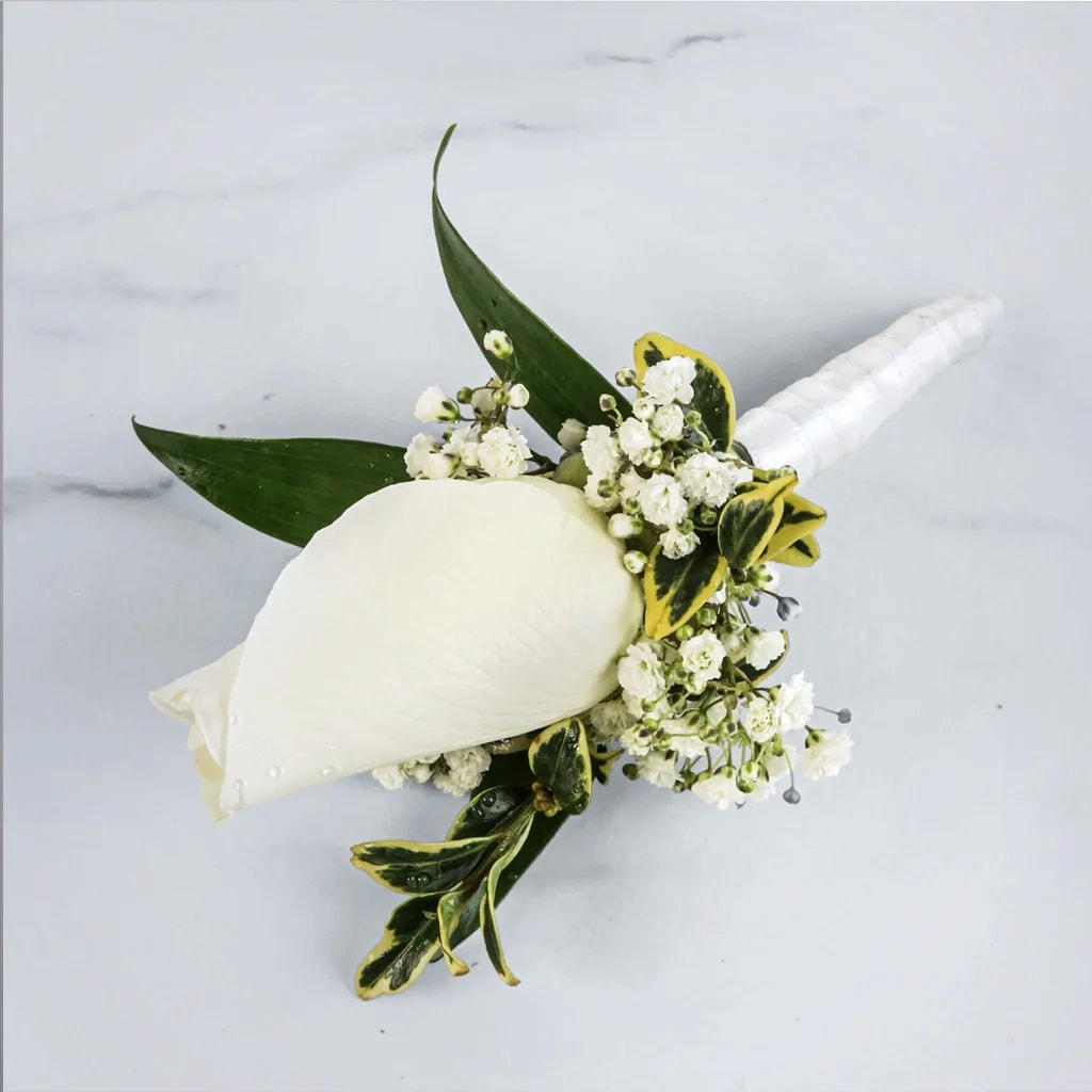Classic White Rose Boutonnière - A classic white boutonnière that complements any suit. A perfect addition for any prom, formal, or wedding event.   Pair it effortlessly with any color palette to create a refined, memorable impression.