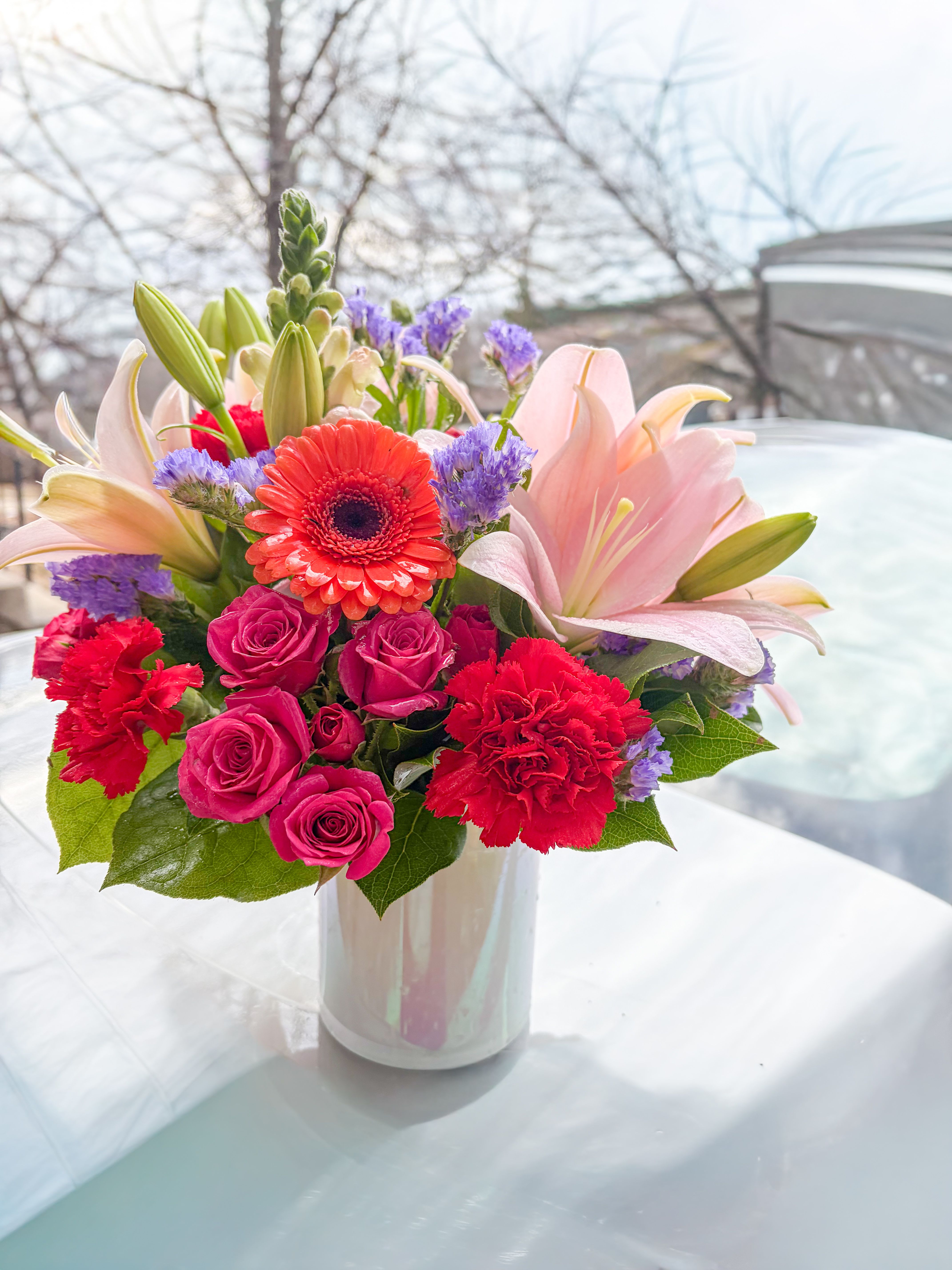 Birthday Bouquet - Stunning bouquet with pink Lillies, orange Gerber's, Hot pink spray roses, Hot pink carnations, Pink snapdragon, and a touch of purple.