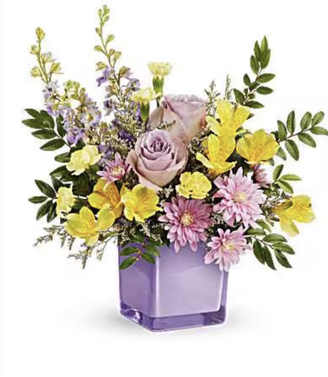 pastel paradise bouquet - A single lavender rose anchors this pastel paradise bouquet, surrounded by airy sprays of yellow and pink daisy-like blooms for a spring-fresh birthday or "just because" surprise. This flower arrangement reads cheerful and gentle at once-perfect as a get-well pick-me-up or a softly romantic gift for the person you want to make feel seen.  Clusters of alstroemeria, chrysanthemums, roses, daisies and carnations mingle in lavender, purple, yellow, pink and fresh green tones, arranged loose and garden-style so stems and filler extend outward in a light, asymmetrical silhouette. The bouquet arrives ready to display in a square purple glass vase that complements the cool lavenders and warm pastels; the assembled size suits a desk, bedside table, or small dining centerpiece.  Send this when you want them to smile - whether it's a birthday, a speedy recovery wish, or an unexpected moment of kindness. For best freshness, keep the vase topped with clean water and trim stems every few days to extend bloom life.