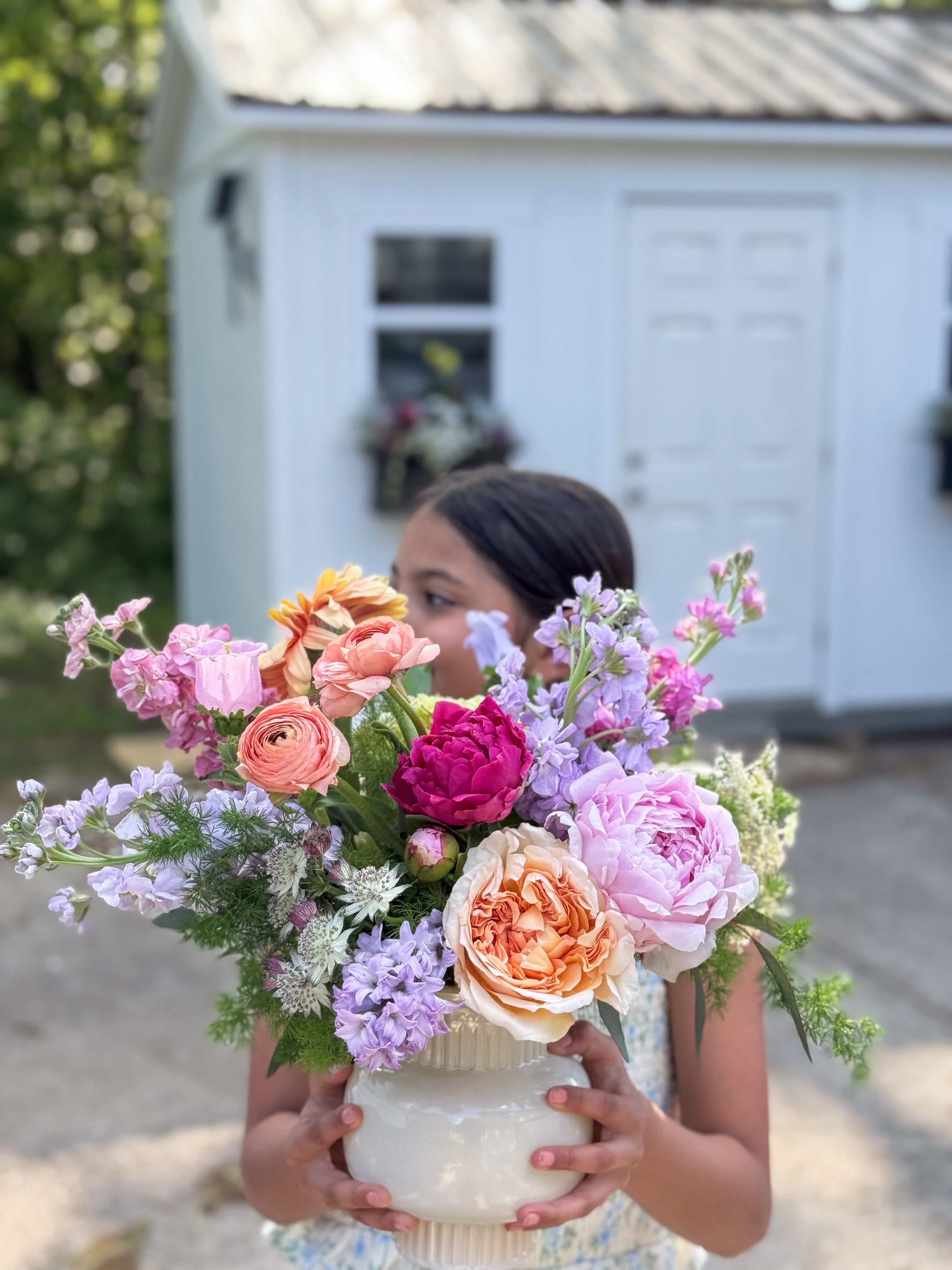 Mamma Mia  -  A magnificent display of garden-like blooms. Seasonal flowers designed in a nude glass vase.