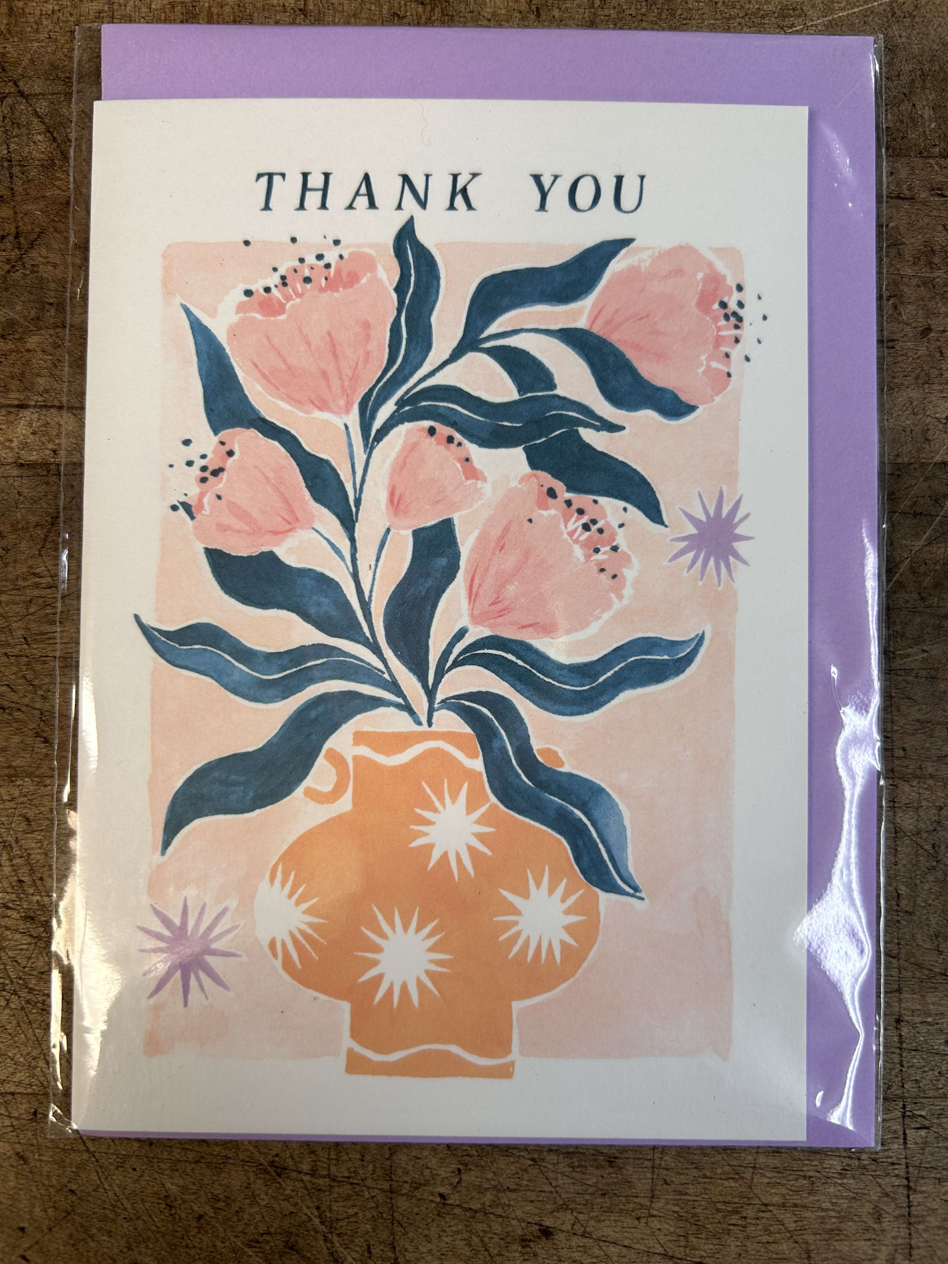 Thank you card with illustration of pink flowers in an orange patterned vase on a lavender backing.