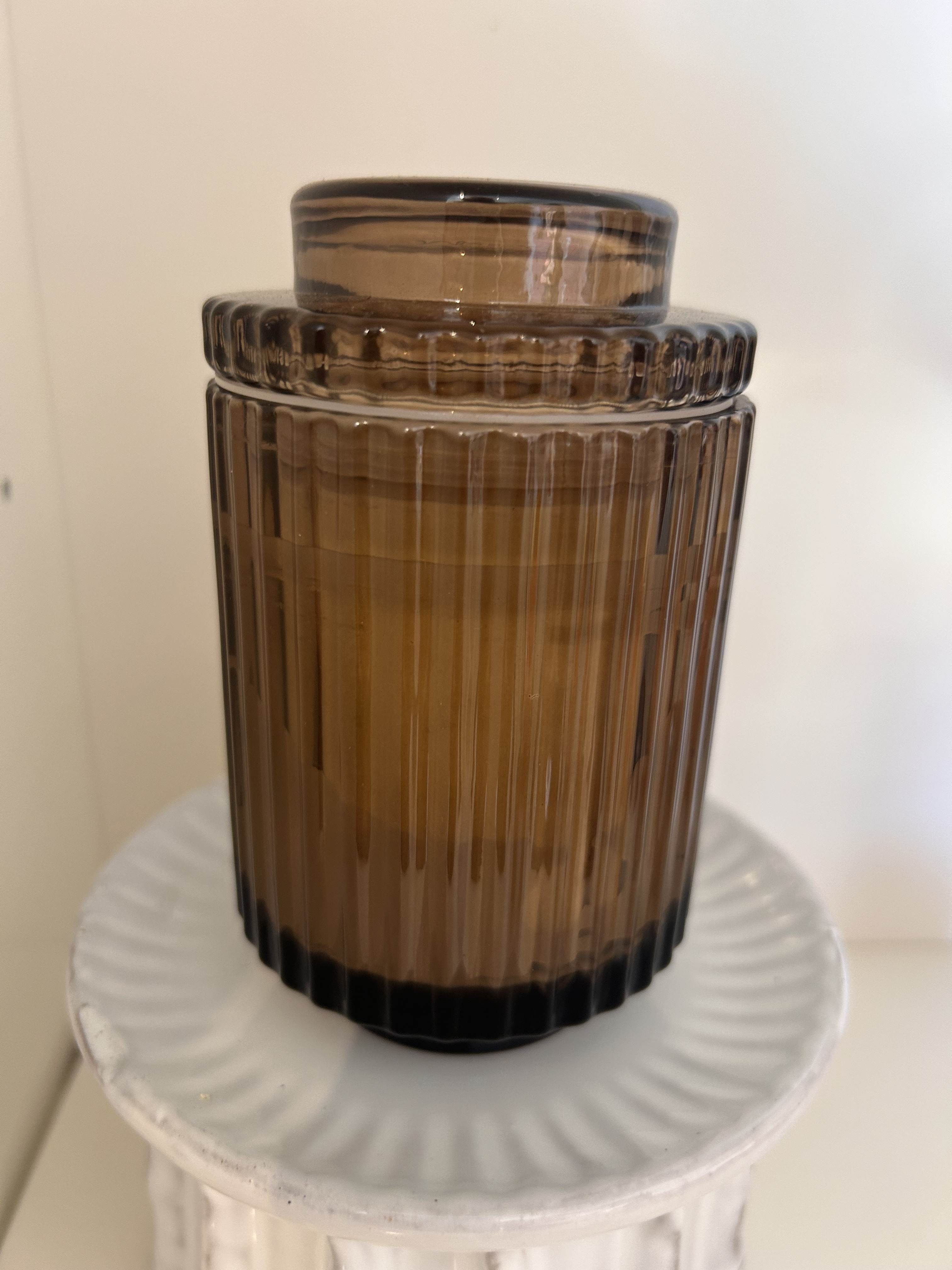 Glass Ribbed Candle Amber -  Timeless ribbed glass candles, reminiscent of the Acropolis grandeur. 40-hour burn with natural soy wax and seamlessly become elegant keepsake containers. Top Notes: Green fig Heart/Middle Notes: Orris Base Notes: Sandalwood, Warm amber