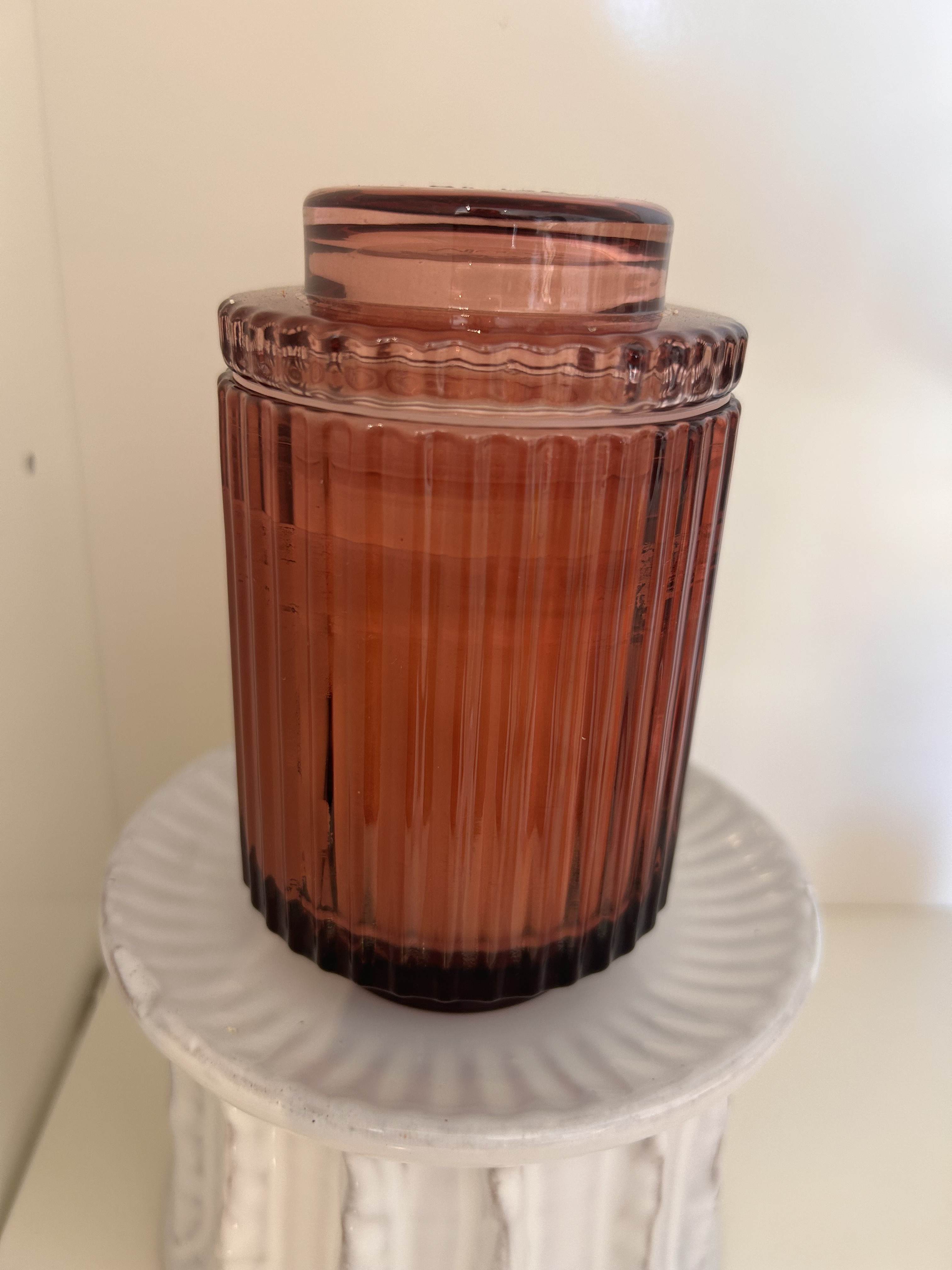 Glass Ribbed Candle Pink - Timeless ribbed glass candles, reminiscent of the Acropolis grandeur. Available in calming colors, they offer a sustainable 40-hour burn with natural soy wax and seamlessly become elegant keepsake containers. Top Notes: Black pepper, Saffron Heart/Middle Notes: Rose, White Amber Base Notes: Patchouli, Leather
