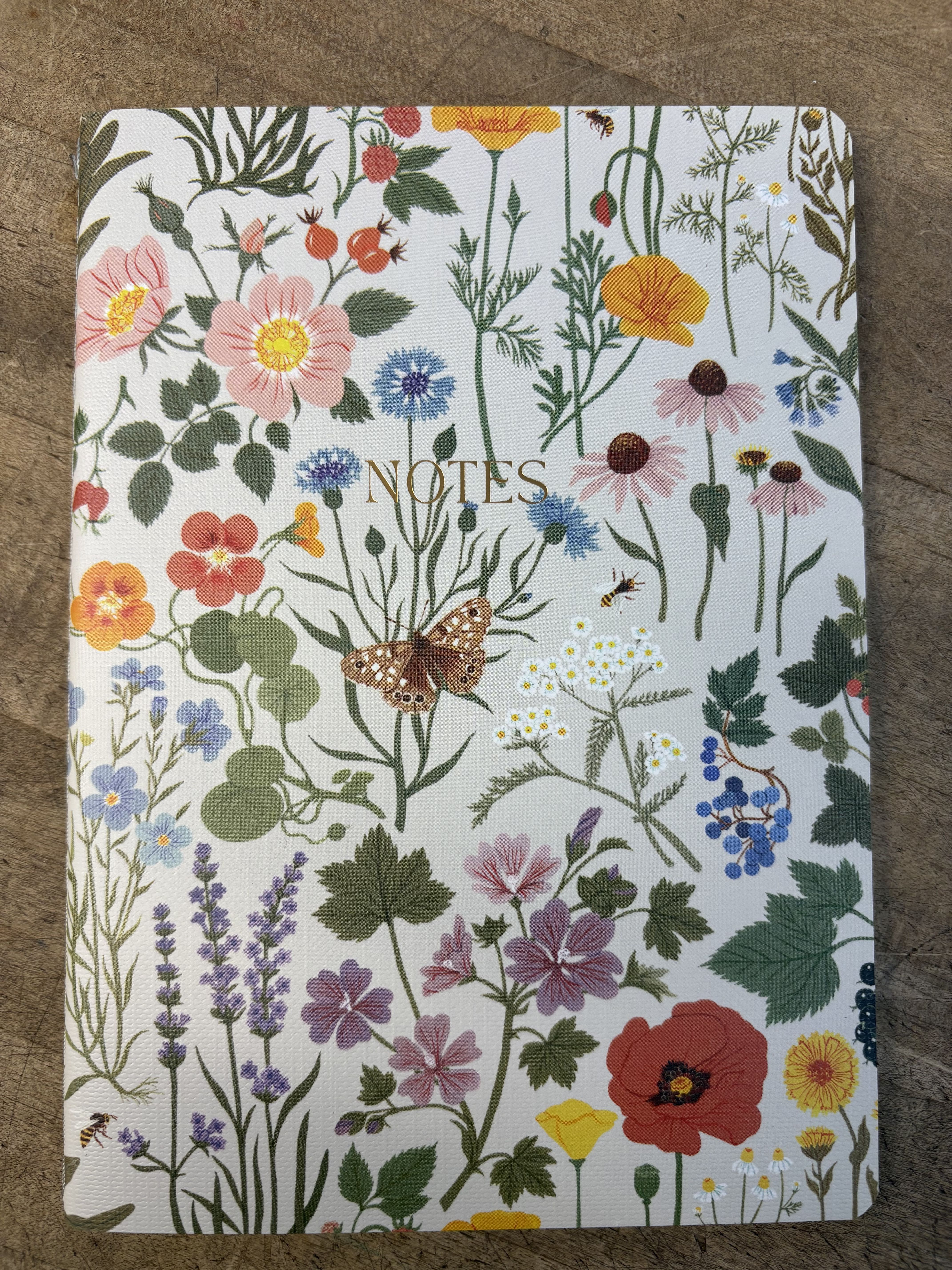 Floral-patterned notebook with the word NOTES on the cover