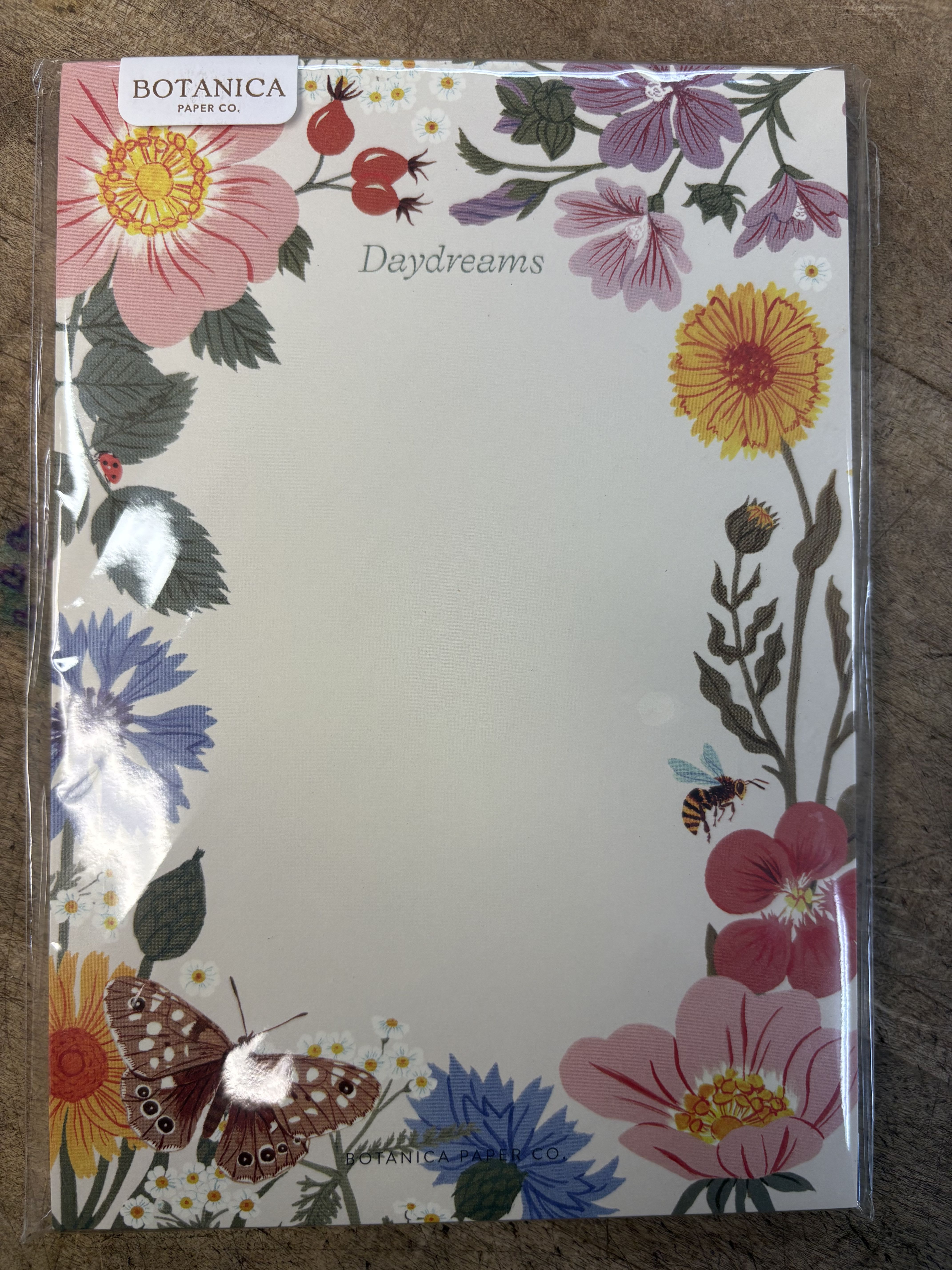 Floral stationery pad with pink, yellow, and purple flowers and butterflies