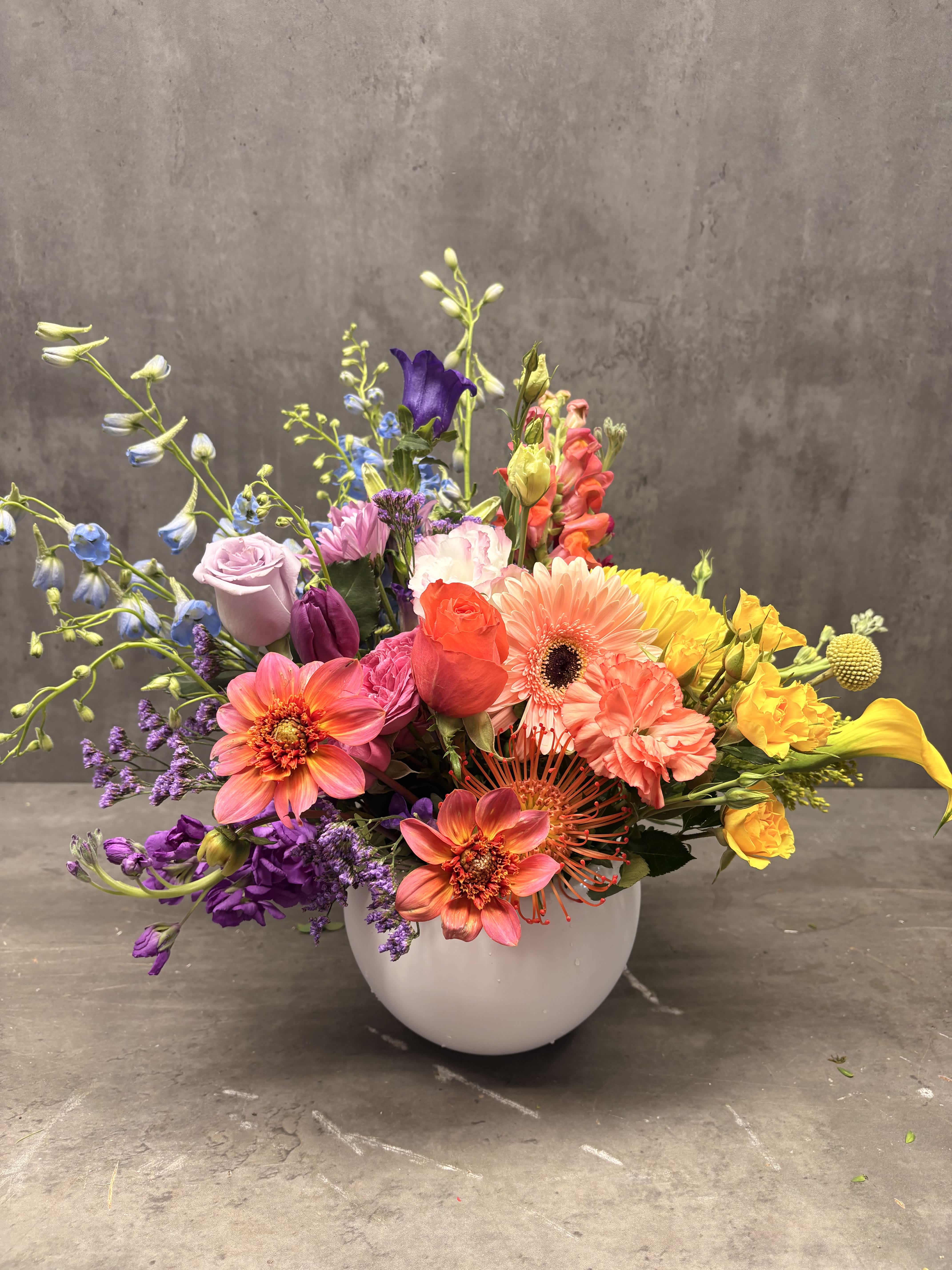 Colorful mixed bouquet in a white round vase