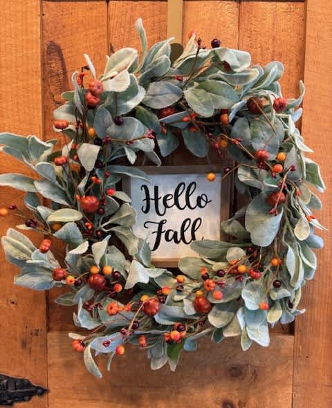 Fall wreath with blue-green leaves and berry accents around a Hello Fall sign