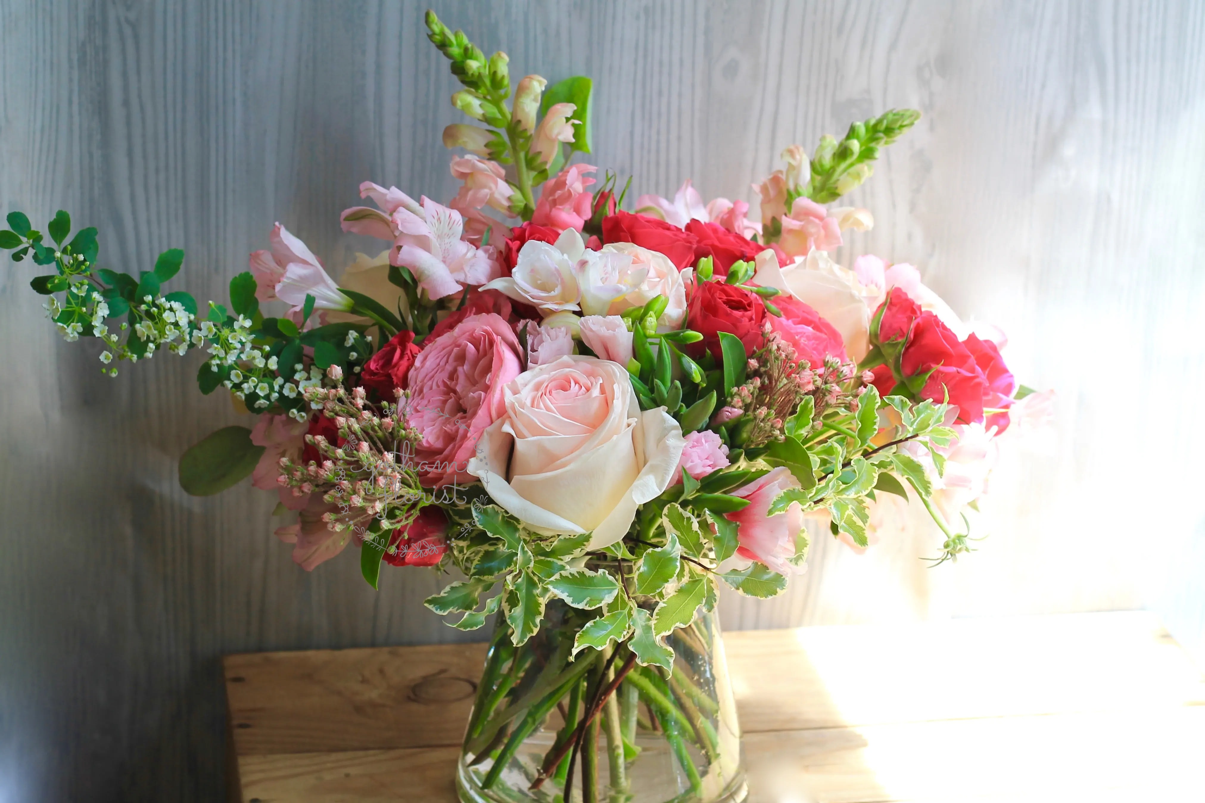 Pink and white rose bouquet in a glass vase