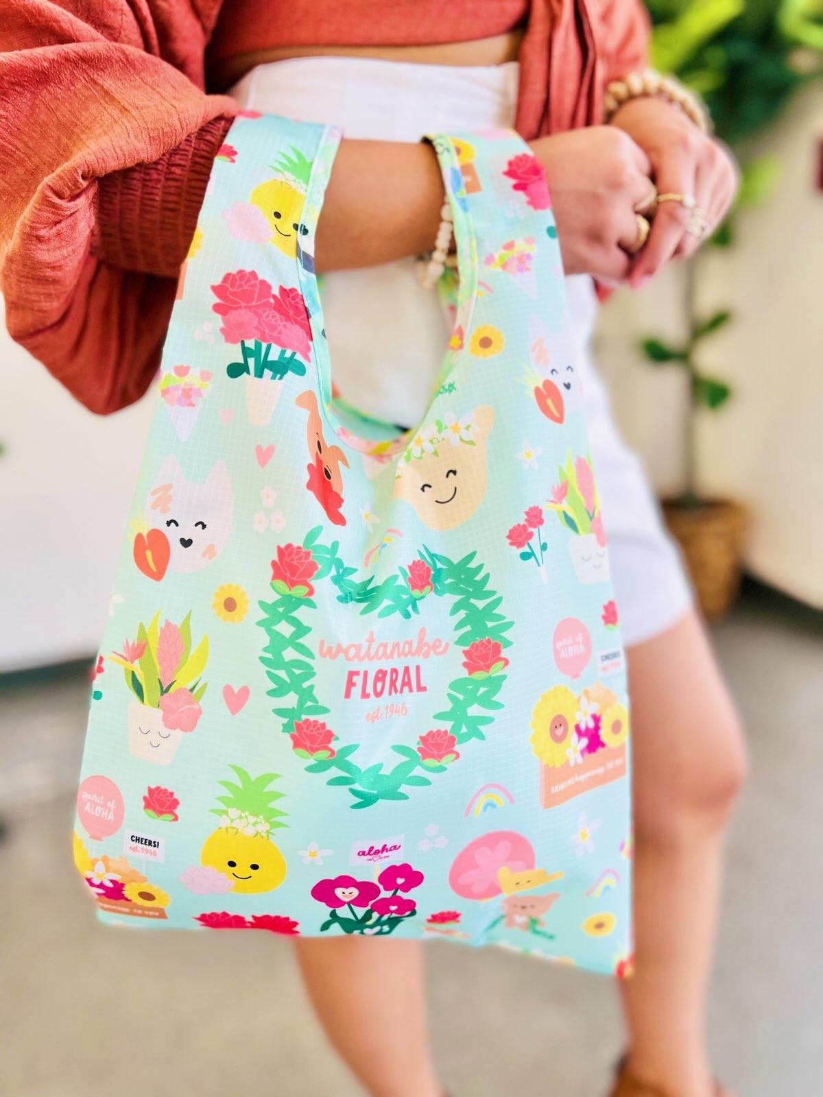 Reusable tote bag with pastel blue background and cheerful floral and fruit cartoons